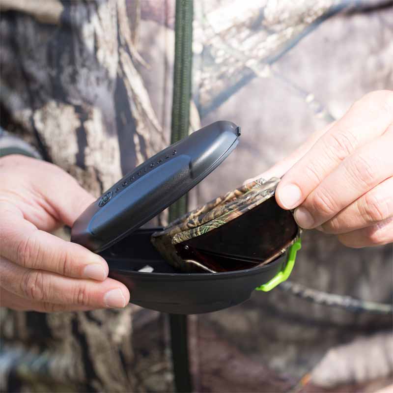 Mossy Oak and Popticals Sunglasses, Hunter putting Popticals Mossy Oak Sunglasses in hard shell case