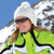 woman on a mountain wearing a snow hat and popticals sunglasses 