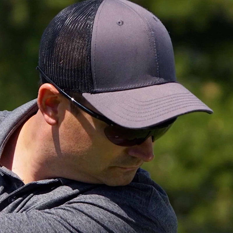 Golfer wearing NYDEF Golf sunglasses demonstrating relaxed visual endurance