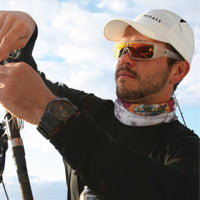 man fishing wearing popticals fishing sunglasses