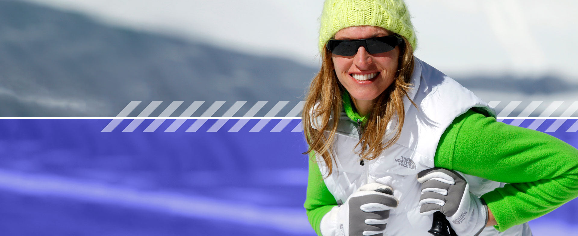 woman skiing wearing popticals sunglasses smiling at the camera 
